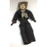 A folk art sailor doll, papier-mâché head with painted features and iron nail ears, 34cm long,