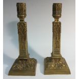 A pair of Gothic Revival gilt brass candlesticks, profusely cast with tracery,