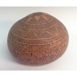 A Colonial engraved gourd, profusely decorated with revelling figures,