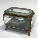 A French gilt metal mounted shaped rectangular table casket, chamfered prismatic panel sides,