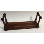 A George IV yew book stand or carrier, turned end supports, the base inlaid with chequered banding,