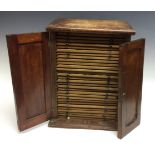 A 19th century mahogany coin cabinet, double fielded panelled doors,