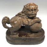A slip-cast model, of a Chinese temple lion, oval base,