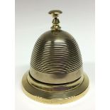 A late Victorian/Edwardian brass counter bell, push button, reeded dome, skirted base, 12.