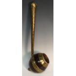 A 19th century coconut shell-dipper, engraved brass mounts and handle, ball feet,