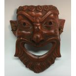 A Greek 'Grand Tour' terracotta mask, the bearded face open-mouthed, 14cm long, marked to verso,