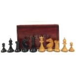A boxwood and ebonised weighted Staunton pattern chess set, the knights with applied eyes,