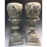 A pair of 19th century grey granite vases, carved with roses, acanthus capped columns,