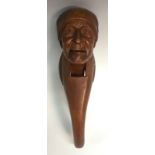 A Black Forest novelty lever nutcracker, carved as the head of a man,