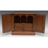 A Victorian mahogany cabinet, fielded paneled doors, the interior with pigeon holes and two drawers,