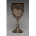 An Edwardian silver ovoid pedestal goblet, chased and engraved with flowers and scrolling leaves,