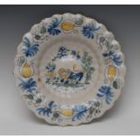 A late 17th century Dutch Delft lobed dish, decorated in polychrome with a lion,