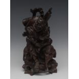 A Chinese hardwood carving, of a sage seated on an elephant, 31cm high,