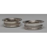 A pair of George IV silver fluted shaped circular wine coasters,