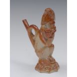 A 19th century brown salt glazed novelty pipe, moulded with monkey, crouching,