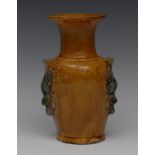 A Chinese pottery vase, glaze in mottled ochre, the floral bouquet tendrils to sides,