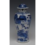 A Chinese slender baluster vase and cover, decorated in underglaze blue with pagoda, horsemen,