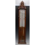 A Victorian Gothic Revival oak Admiral Fitzroy barometer, paper scale, mercury cistern,