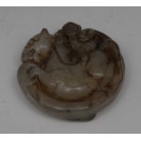 A Chinese jade roundel, carved as a monkey riding a horse, 5.