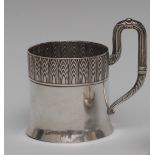 A large Russian silver tea glass holder, embossed with a deep stylised band,