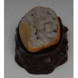 A Chinese pale celadon and russet jade boulder shaped carving,