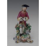 A Bow figure, Allegorical of Winter, modelled with a man wearing a tricorn hat, pink jacket,