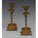 A pair of French gilt metal and champleve enamel candlesticks, urnular sconces, detachable nozzles,