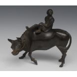 A Chinese dark patinated bronze censor and cover, cast as a boy riding an ox, 22cm wide,