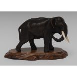 Japanese School (Meiji period), a dark patinated bronze, of an elephant, striding forward,