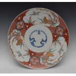 A large Japanese circular charger, the centre with prunus tree roundels,