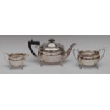 A George V silver three piece boat shaped tea service, comprising teapot,