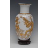 A Chinese opaque glass ovoid vase, boldly applied with a gilt dragon and pagoda, seal mark, 29.