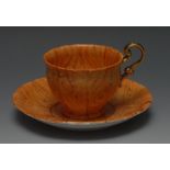 An English Porcelain teacup and saucer, decorated overall with faux wood, gilt handle,
