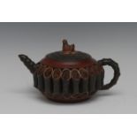 A Chinese Yixing terracotta teapot and cover, applied with sections of bamboo,