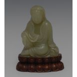 A Chinese pale jade carving, of Guanyin, seated serene, in meditation, 7.