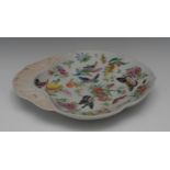 An 18th century Chinese shell shaped dish, decorated with butterflies, crickets, peaches,