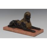 French School (19th century), a dark patinated and parcel gilt bronze library model, of a sphinx,