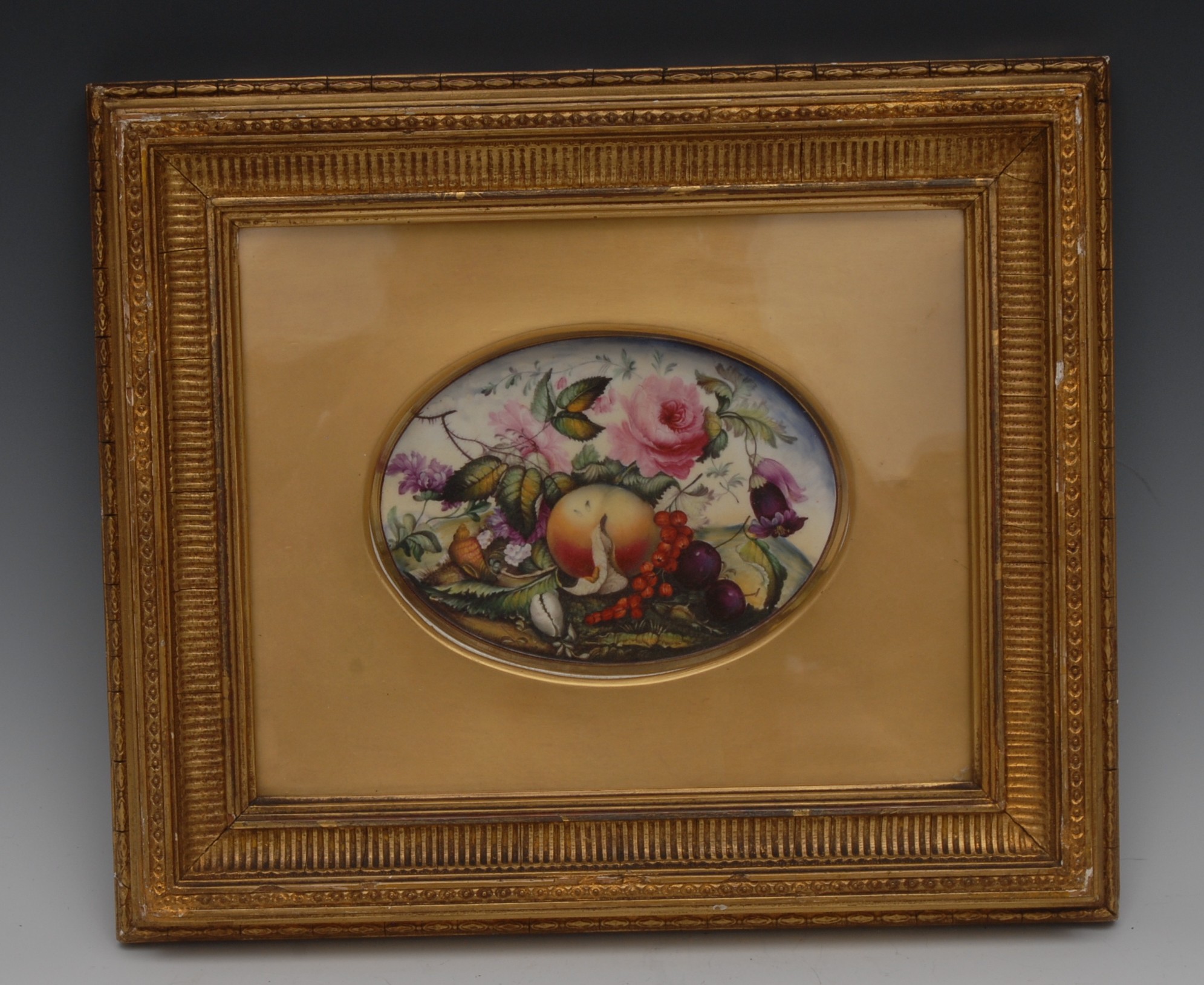An English Porcelain oval plaque, well painted with peaches, peonies, berries, shells and foliage,
