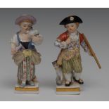 A pair of Meissen figures, of a girl and a boy, she holding a bird, she wearing a lilac bonnet,