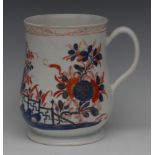 A Bow slightly waisted mug, decorated in the imari style with fence, holed rock and flowers,