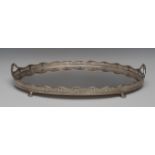 A large silver oval two-handled gallery tray, plain field, the undulating sides with husk swags,