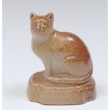 A Brampton brown salt glazed stoneware model of a cat, canted rectangular base, 7.