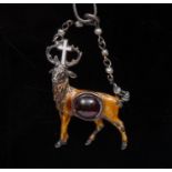 A 19th century silver and enamel St Hubertus pendant, the stag set with red garnet,