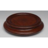 A George III turned mahogany circular magnum or decanter table coaster, wooden casters, 25cm diam,