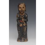 A South American carved and polychrome painted santos figure, of St Peter, he stands,