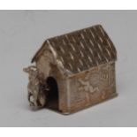 A Dutch silver miniature novelty toy, as a dog and kennel, the side embossed with putti, 4cm long,