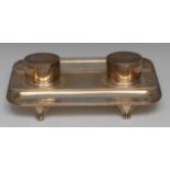 A George VI silver rounded rectangular inkstand, quite plain, oval wells with glass liners,