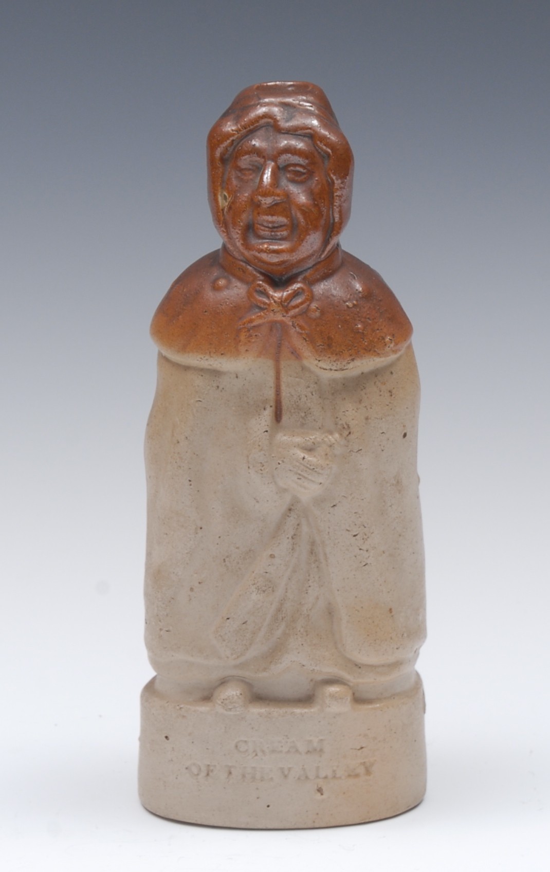 A 19th century brown salt glazed stoneware figural flask, Cream of the Valley,