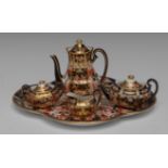 A composed Royal Crown Derby 6299 pattern miniature tea service, comprising coffee pot,