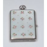 An early 20th century silver and enamel rounded rectangular compact,